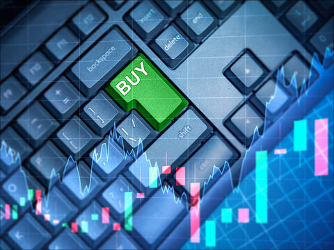 A computer keyboard with a large green Buy button. A signal to buy shares on the background of the stock chart. The concept of exchange trading. The stock market. Stock exchange information.