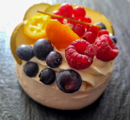 Mini pavlova meringue cake with fresh berries and whipped cream. Morning. 