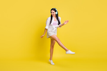 Fototapeta na wymiar Full body photo of attractive funky woman dance dreamy wear headset isolated on yellow color background