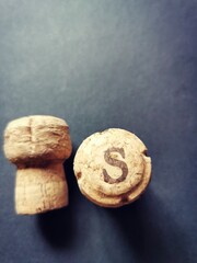 Champagne corks on a black table.