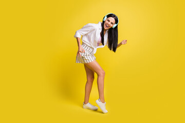 Fototapeta na wymiar Full body profile side photo of crazy happy young woman play imagine guitar wear headset isolated on yellow color background