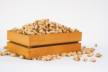 Pistachio nuts in box on white background.  Product for sale.  Copy space. Studio photo. Free space for text. Products show for sale. Health food. Vegetarian Diet.  Studio photo. Copy space. 