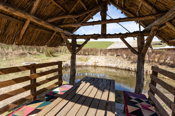 A Wooden Gazebo over a Beautiful Blue Pond