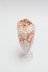 Tasty milk shake with chocolate topping on white background