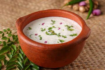 Spiced buttermilk , chaas , chaach , moru , sambharam , curd, lassi , yogurt, cool refreshing drink for hot summer in a clay pot, Kerala, India. Flavored Indian buttermilk.
