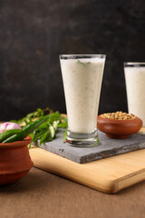 Spiced buttermilk , chaas , chaach , moru , sambharam , curd, lassi , yogurt, cool refreshing drink for hot summer in glass , Kerala, India. Flavored Indian buttermilk.