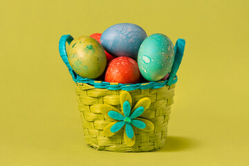Colorful Easter eggs in handmade basket