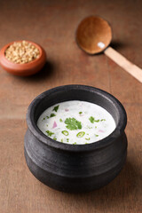 Spiced buttermilk , chaas , chaach , moru , sambharam , curd, lassi , yogurt, cool refreshing drink for hot summer in a clay pot, Kerala, India. Flavored Indian buttermilk.