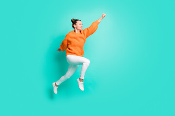 Fototapeta na wymiar Full size profile photo of optimistic nice brunet lady jump wear sweater jeans isolated on teal background