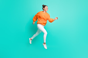 Fototapeta na wymiar Full size photo of young attractive lovely smiling girl running in air looking copyspace isolated on teal color background