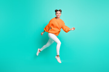 Fototapeta na wymiar Full size photo of young lovely charming positive girl running in air wear knitted pullover isolated on teal color background