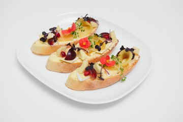 Different kinds of colorful sandwiches on black chalkboard background from above (top view). Party starter or appetizer - flat lay composition.