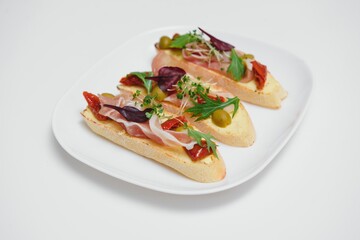 Different kinds of colorful sandwiches on black chalkboard background from above (top view). Party starter or appetizer - flat lay composition.