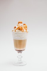 Tasty milk shake with chocolate topping on white background