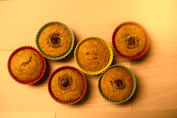 Group of homemade banana muffins on wooden background.
