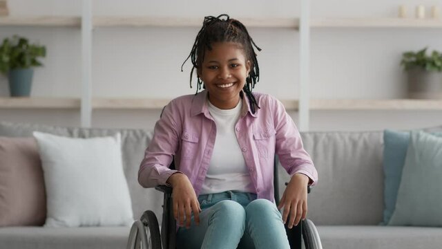 Happy Disabled Black Teen Girl Posing In Wheelchair At Home