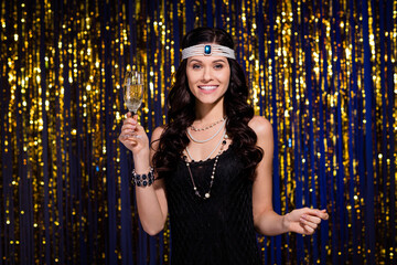 Photo of adorable sweet young woman dressed black outfit headband drinking wine isolated gold shine...