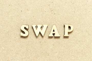 Alphabet letter in word swap on wood background