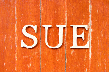 Alphabet letter in word sue on old red color wood plate background