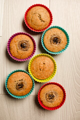 Group of homemade banana muffins on wooden background.