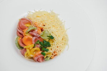 Pasta with meat, tomato sauce, parmesan and vegetables