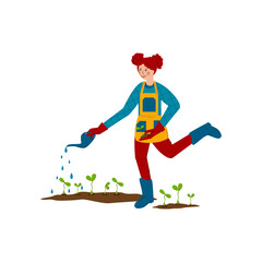 Happy girl is watering young seedlings. Spring work in the garden. Water is pouring out of the watering can.