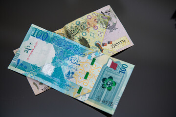 Doha, Qatar - April 08, 2021: New and old Qatri 100 Rial Bank Note. 
