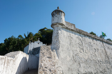 Historic building Barra Grande Fortress. Guardhouse, high wall and church.