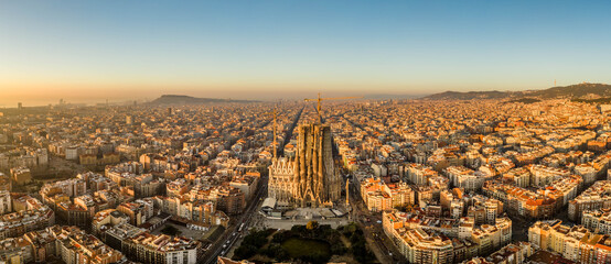 Aerial panorama drone shot of Barcelona city center in sunrise golden hour in Spain winter