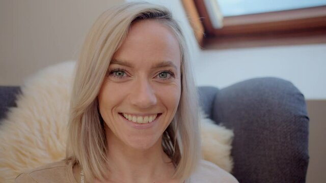Slow motion of beautiful young woman reading book and smiling in camera. 