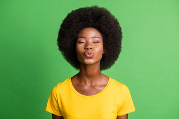 Photo portrait of romantic flirty girlfriend sending air kiss isolated on vivid green color...