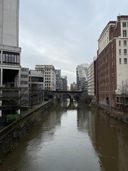 Fototapeta na wymiar A river running through Manchester City centre with modern architecture and landmark buildings. 