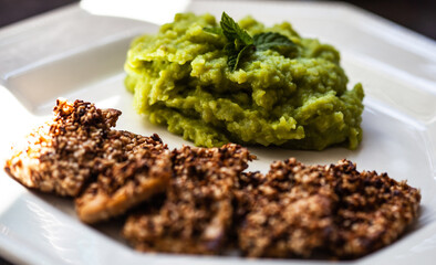 Fried tofu with sesame and pea, potato and mint puree.