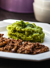 Fried tofu with sesame and pea, potato and mint puree.