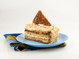 image of a cake piece lie on ceramic plate over a white background