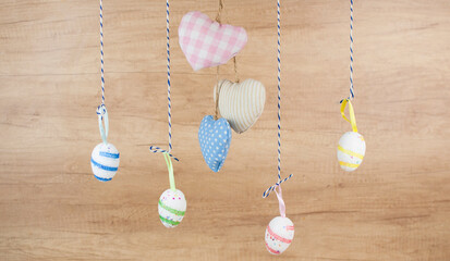 Fototapeta na wymiar Colorful easter eggs hanging on wooden wall copy space.