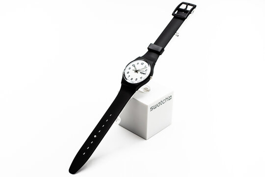 Rome, Italy 07.10.2020 - Swatch simple fashion swiss made quartz watch isolated on white. black plastic case and strap. Swatch Group watch production