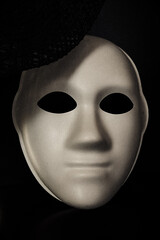 a white mask without a face on a black background. halloween background