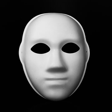 white mask in the form of a human face on a black background