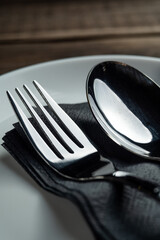 Spoon and fork on a wooden restaurant background, stainless steel cutlery