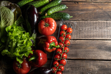 Multiple fresh organic vegetables on a wooden background