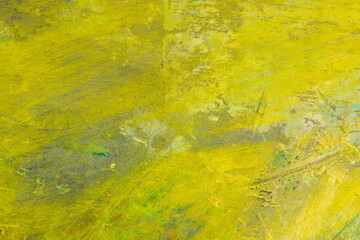 colorful creative motley background: smudged residues of oil paints on a wooden palette, short focus, selective blur