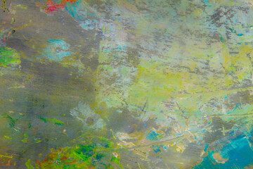 Fototapeta na wymiar colorful creative motley background: smudged residues of oil paints on a wooden palette, short focus, selective blur