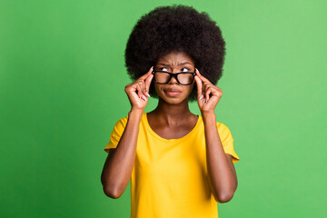 Photo of young unhappy upset thoughtful minded afro girl in glasses look copyspace thinking...