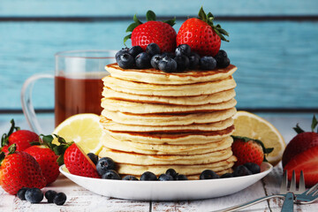 A stack if home-made pancakes with berry