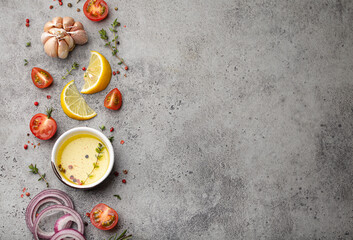 Fototapeta na wymiar Food cooking background on grey stone rustic table with fresh ingredients, vegetables, herbs, spices, olive oil from above with space for text