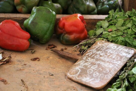 Fresh sweet pepper, green, red on wooden table with wooden chulk board