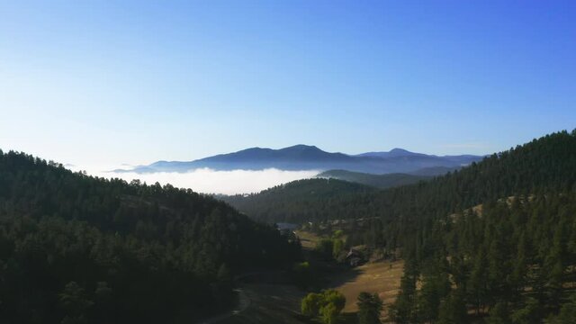 foggy sunrise in the mountains from a drone in colorado
