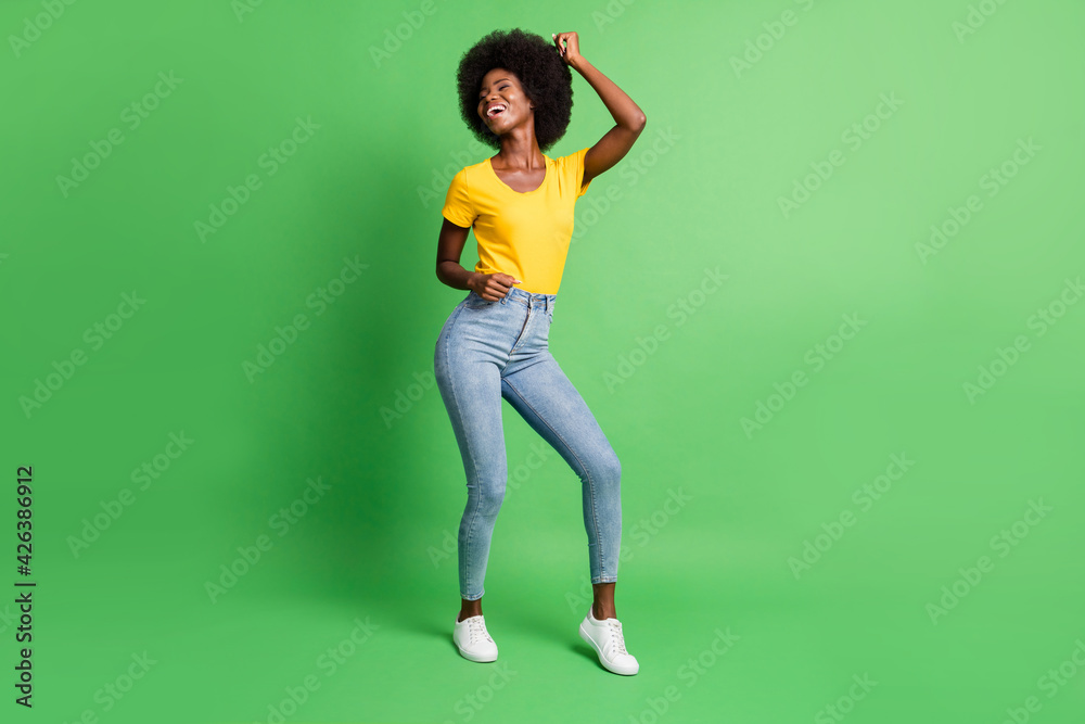 Wall mural Full length body size photo of dancing overjoyed girl laughing at party isolated on vibrant green color background - Wall murals