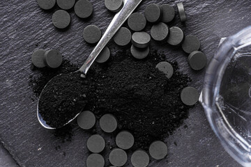 activated carbon on a dark stone background